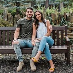 couple snuggling on a bench in the garden